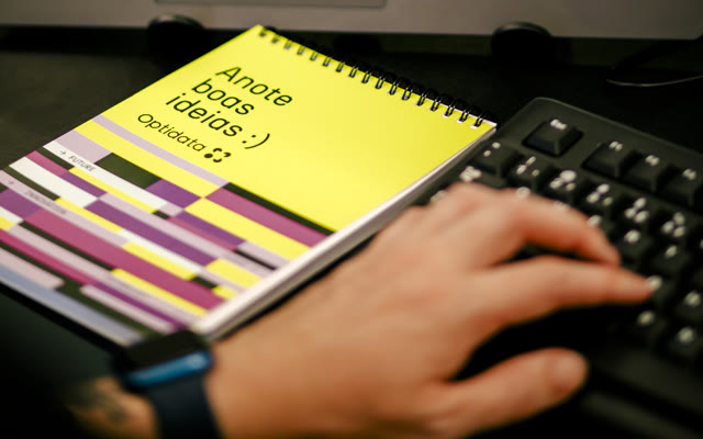Optidata notebook on a desk beside a keyboard